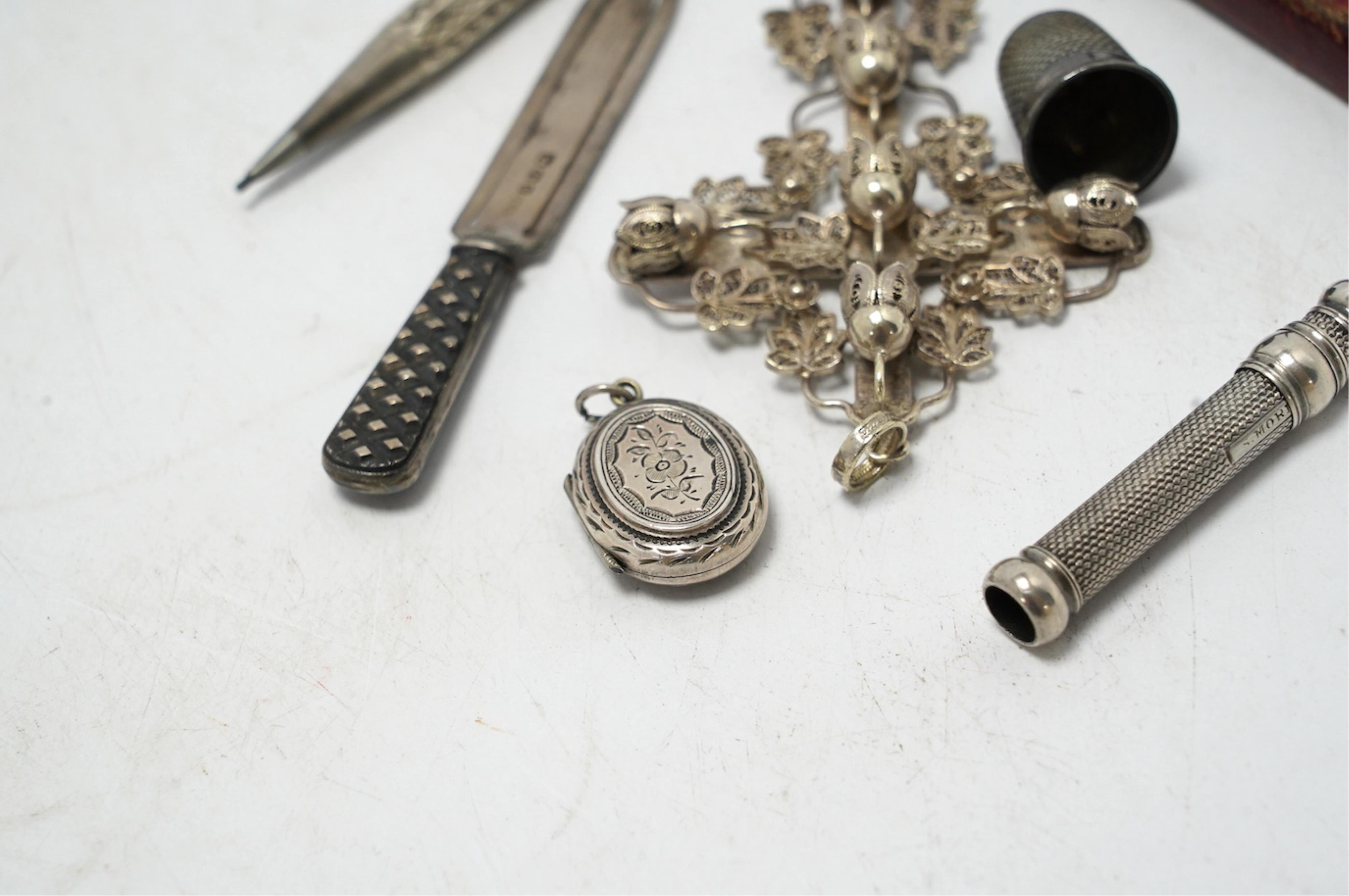 Small silver including a Victorian silver and mother of pearl fruit knife, a crucifix, a book mark, pencils, a thimble, etc. Condition - fair